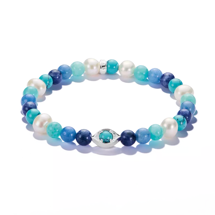 A beaded stretch bracelet featuring a mix of white pearls, light and dark blue beads, and turquoise-blue marbled beads, accented by a silver-tone evil eye charm with a turquoise center, shown on a clean white background.