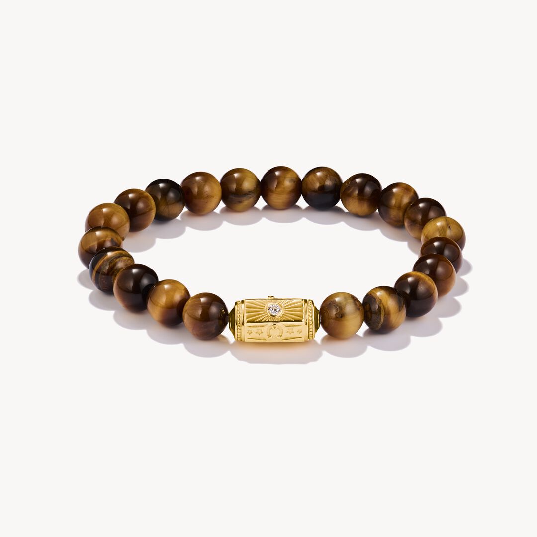 Bracelet with brown beaded design and gold clasp on a white background