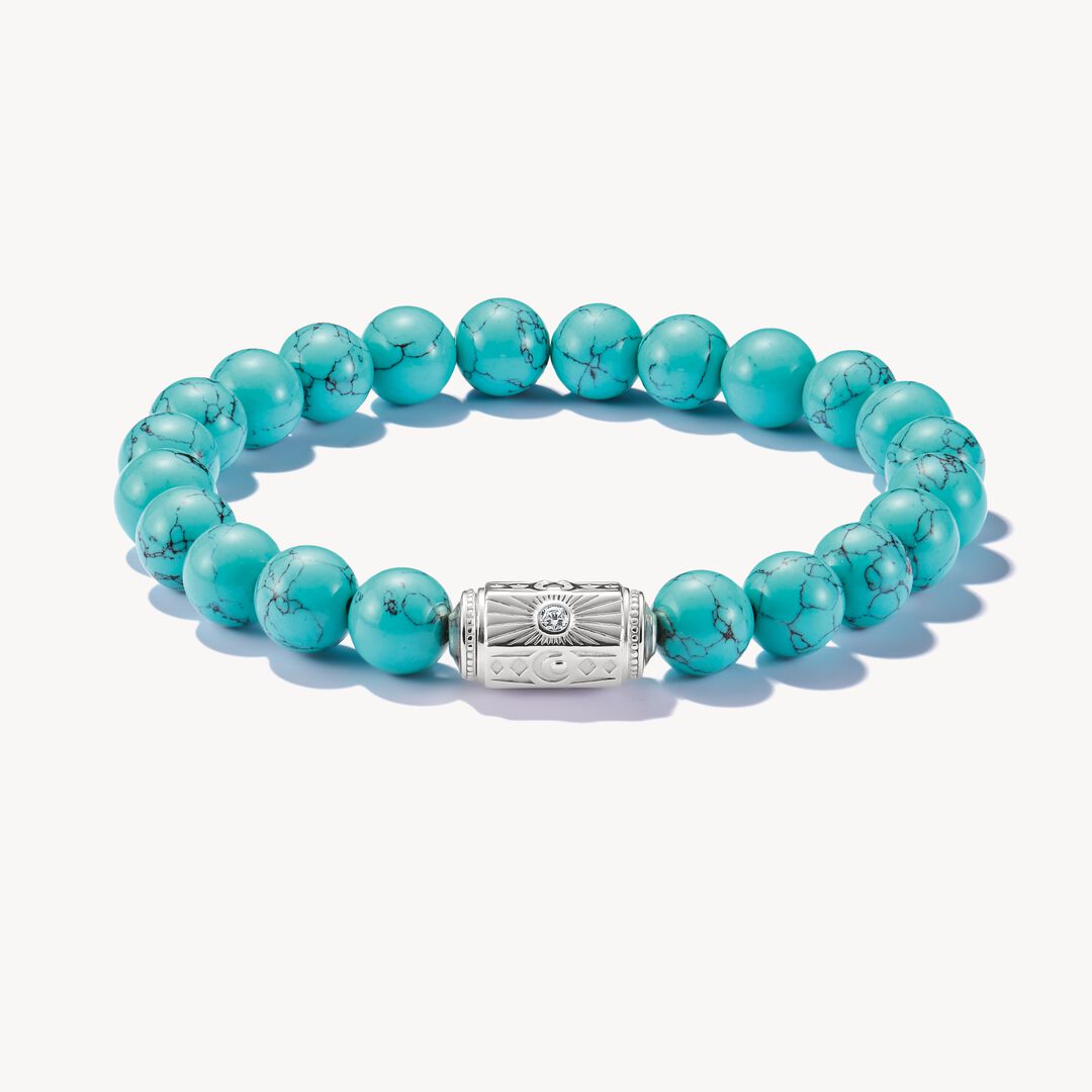 Turquoise beaded bracelet with a silver clasp on a white background