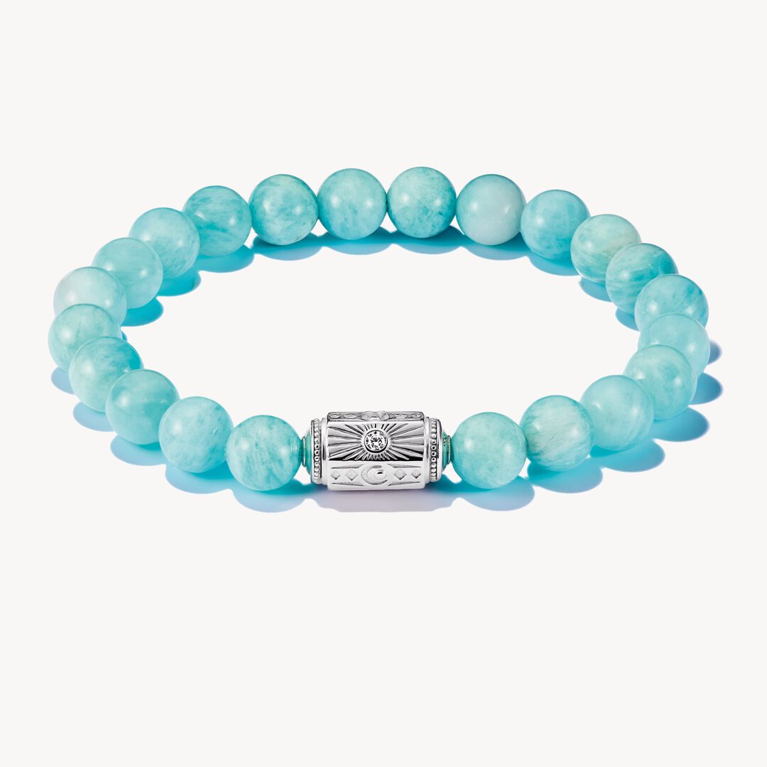 Turquoise beaded bracelet with a silver clasp on a white background