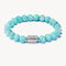 Turquoise beaded bracelet with a silver clasp on a white background