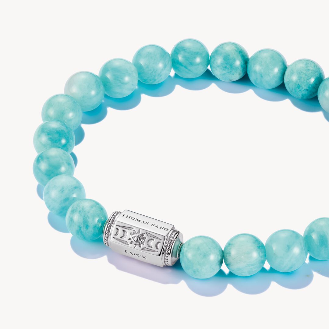 Turquoise beaded bracelet with a silver clasp on a white background