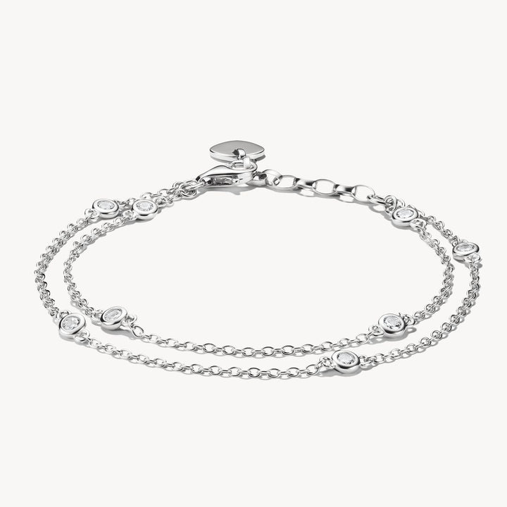 Silver bracelet with heart-shaped charms on a white background