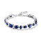 A silver bracelet featuring multiple oval-cut deep blue gemstones in bezel settings, arranged in a repeating pattern, shown on a clean white background.