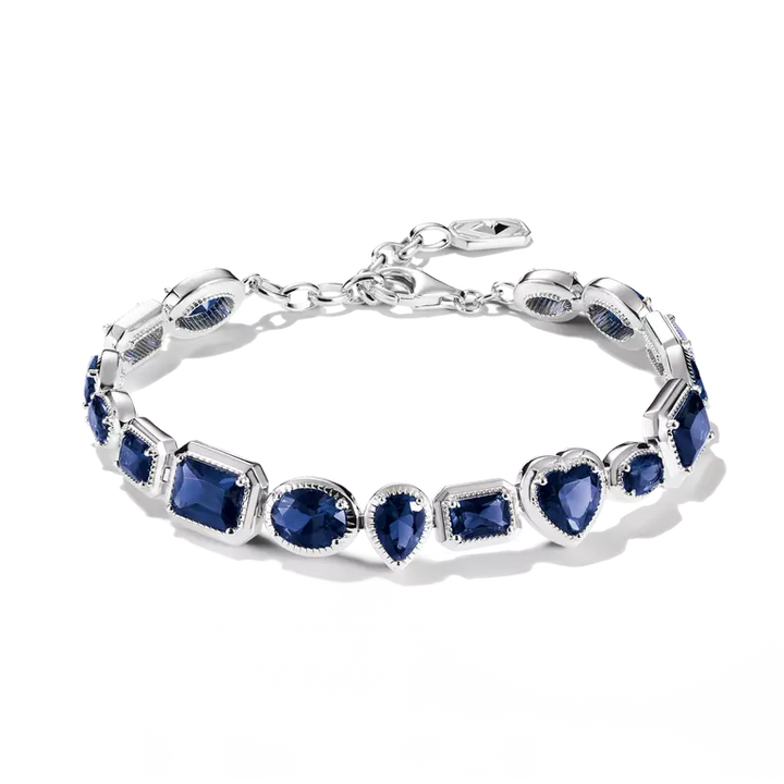 A silver bracelet featuring multiple oval-cut deep blue gemstones in bezel settings, arranged in a repeating pattern, shown on a clean white background.