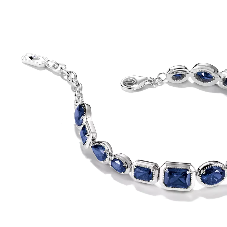 A silver-toned bracelet featuring alternating marquise and square-cut deep blue gemstones in bezel settings, shown on a clean white background.