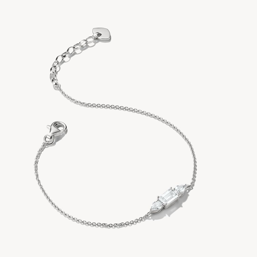 Silver bracelet with a clear gemstone on a white background