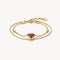Gold bracelet with heart-shaped red gemstone on a white background