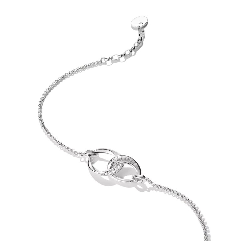 A silver chain bracelet featuring two interlocking oval links, one of which is set with small clear stones, shown on a clean white background.