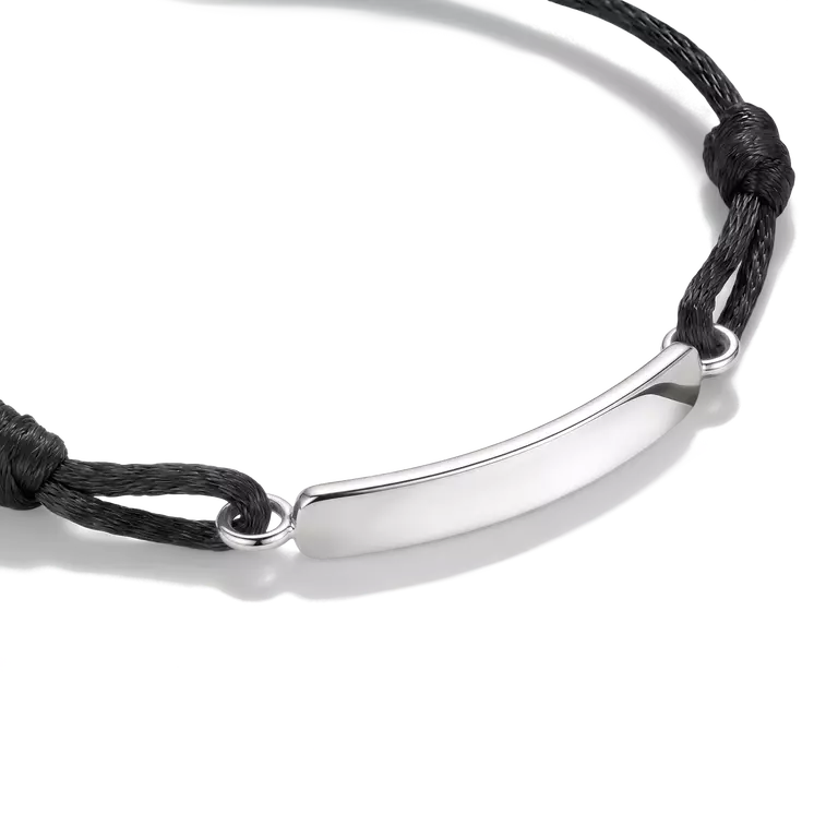 A silver curved bar nameplate bracelet on a black adjustable cord, shown on a clean white background.