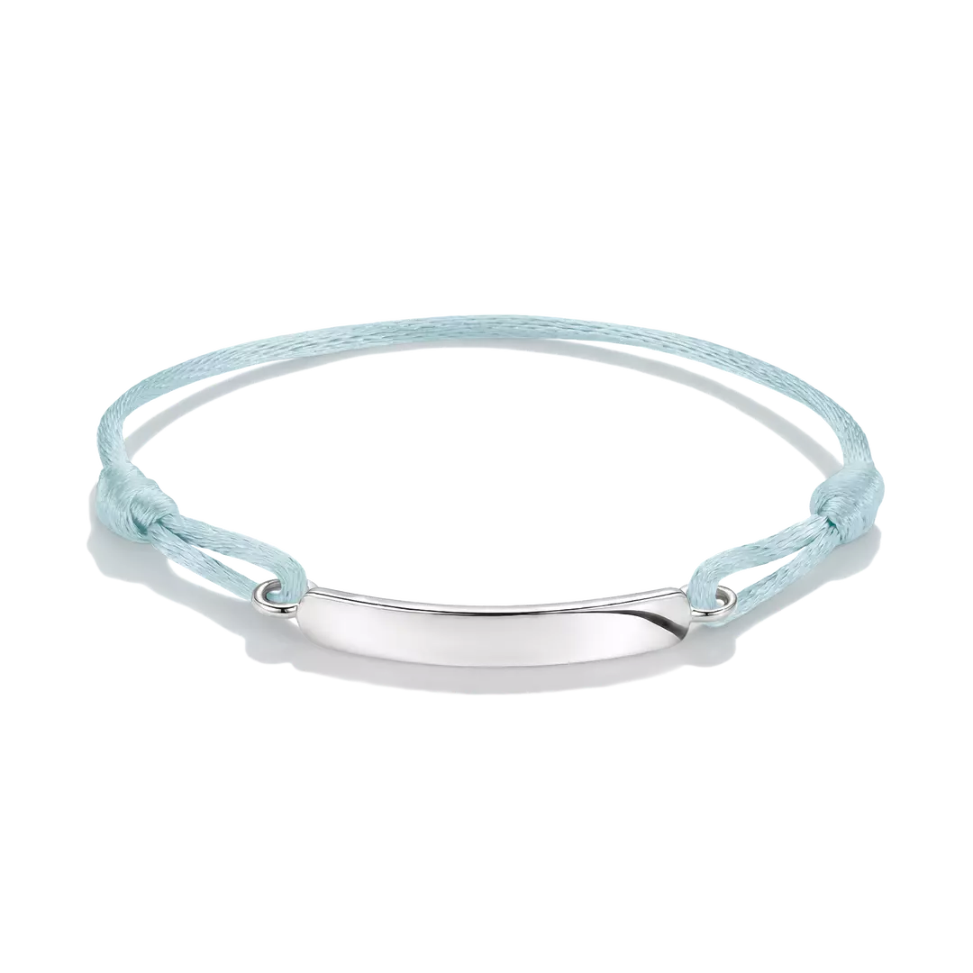 A delicate pink cord bracelet with a polished silver-tone oval plate in the center, displayed on a clean white background.