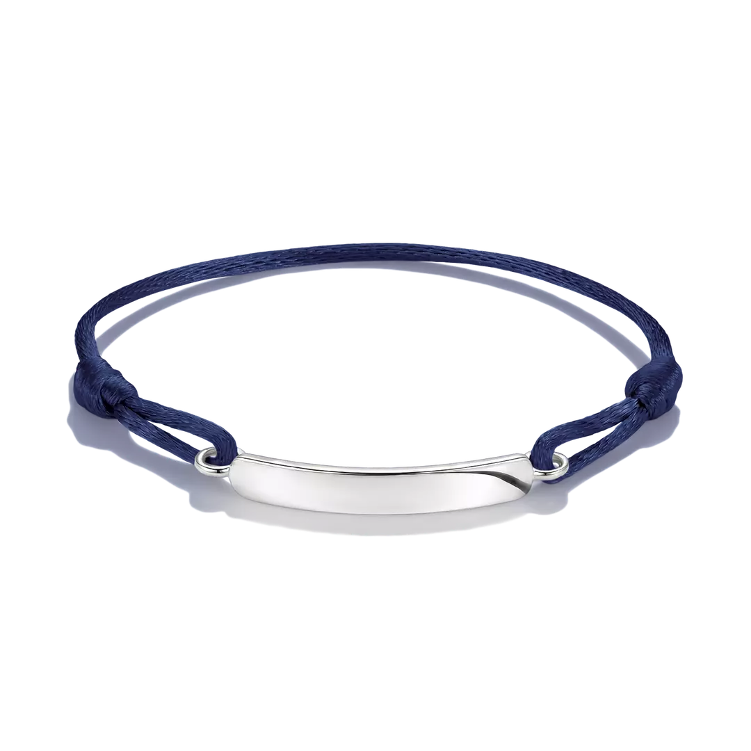 A navy blue cord bracelet with a polished silver-tone oval ID plate, shown on a clean white background.
