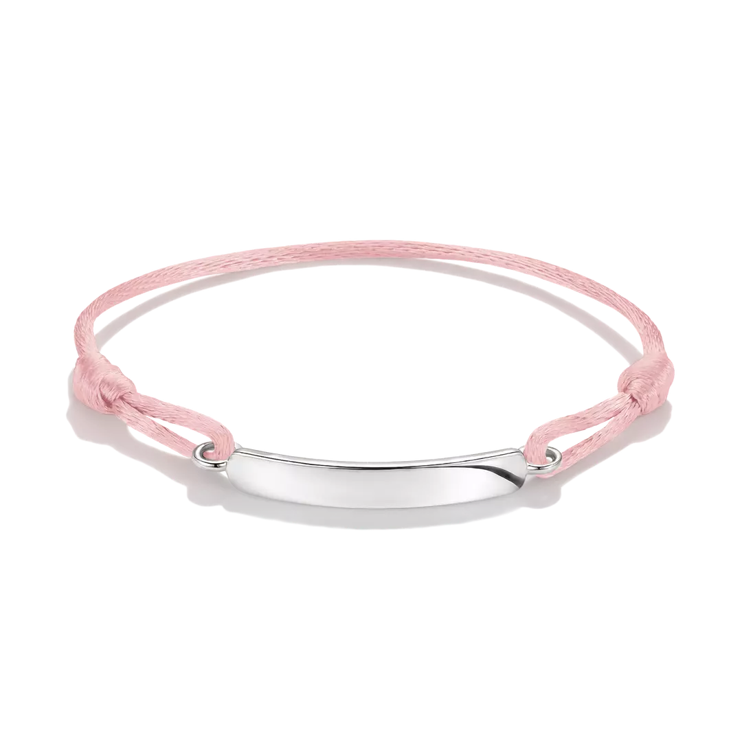 A delicate pink cord bracelet with a polished silver-tone oval plate in the center, displayed on a clean white background.
