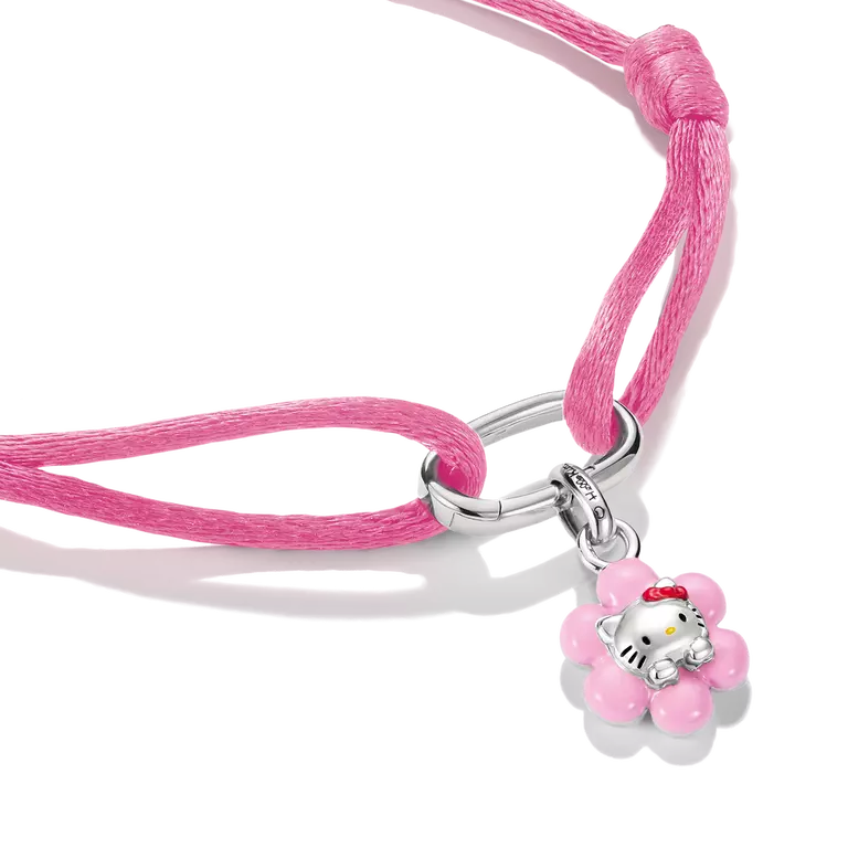 A pink braided cord bracelet featuring a silver-toned metal clasp and a Hello Kitty flower charm, displayed on a clean white background.