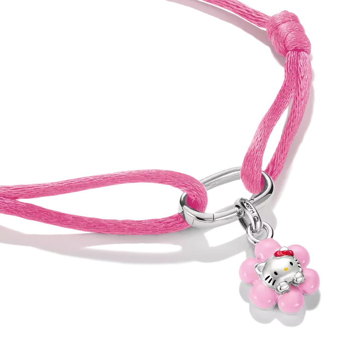 A pink braided cord bracelet featuring a silver-toned metal clasp and a Hello Kitty flower charm, displayed on a clean white background.