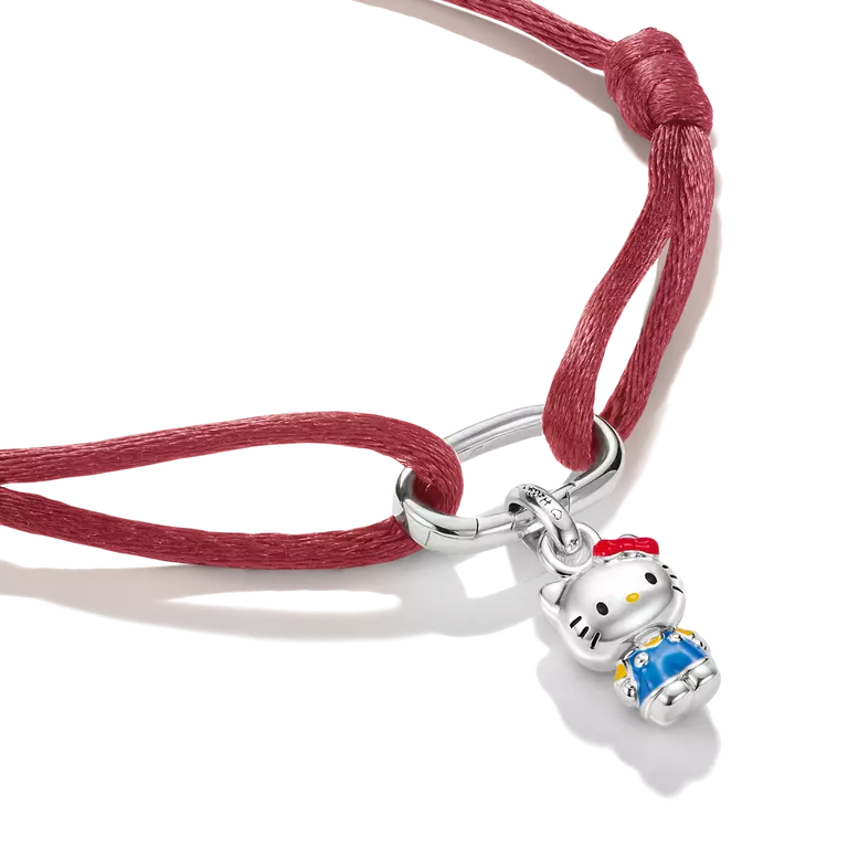 A sterling silver Hello Kitty charm pendant on a red adjustable cord bracelet, shown on a clean white background.