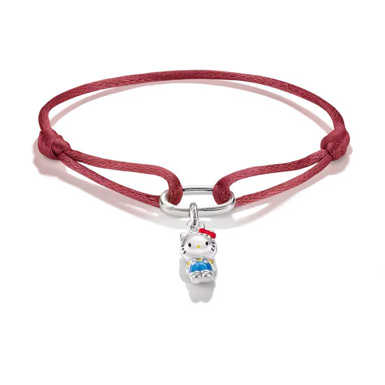 A red braided cord bracelet featuring a silver metal clasp and a small Hello Kitty charm with white, red, and blue enamel details, set against a plain white background.