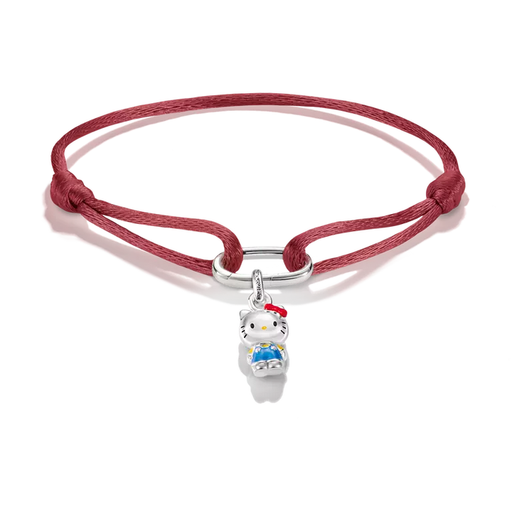 A red braided cord bracelet featuring a silver metal clasp and a small Hello Kitty charm with white, red, and blue enamel details, set against a plain white background.