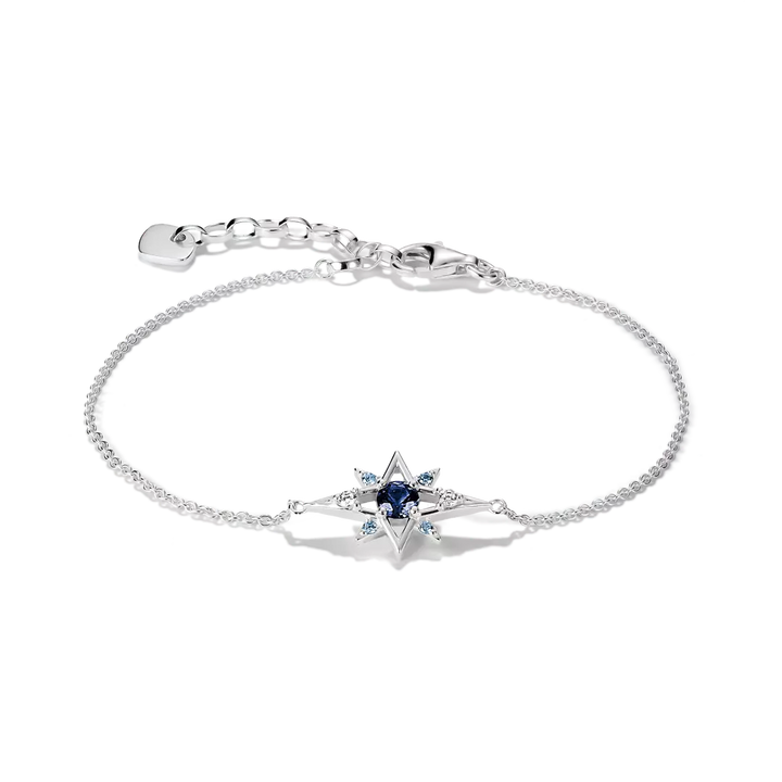A silver chain bracelet with a central star-shaped charm featuring a dark blue oval center and small light blue stones, shown on a clean white background.
