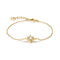 A delicate gold chain bracelet featuring a central starburst charm set with a clear round gemstone and small accent stones, displayed on a clean white background.