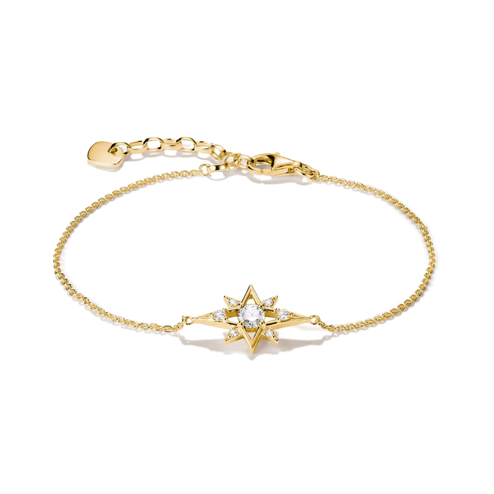 A delicate gold chain bracelet featuring a central starburst charm set with a clear round gemstone and small accent stones, displayed on a clean white background.