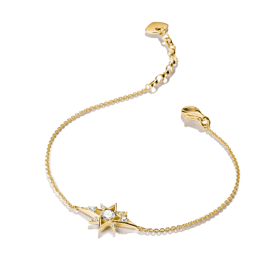 A delicate gold chain bracelet featuring a central starburst charm set with a clear round gemstone and small accent stones, displayed on a clean white background.