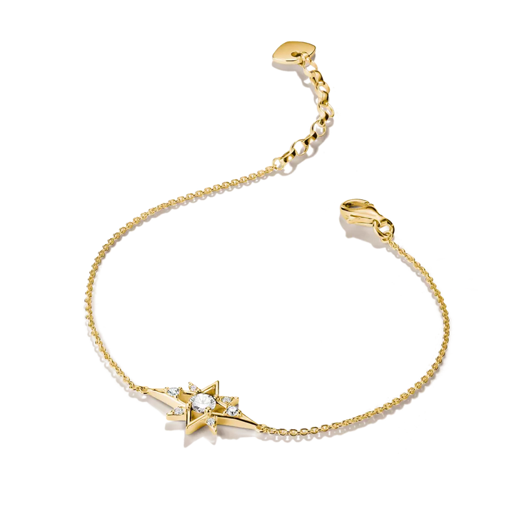 A delicate gold chain bracelet featuring a central starburst charm set with a clear round gemstone and small accent stones, displayed on a clean white background.
