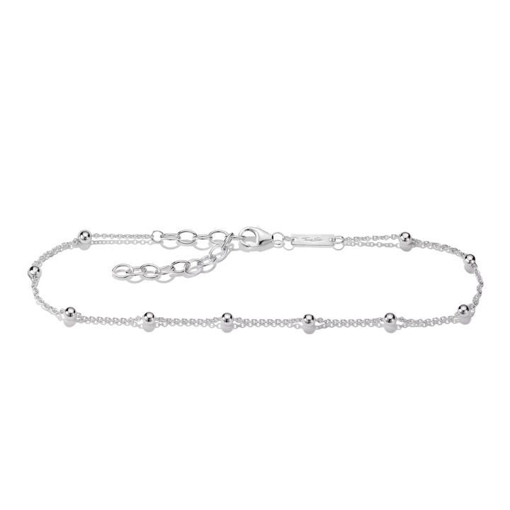 A delicate silver chain bracelet with small polished bead accents spaced along the front, displayed on a clean white background.