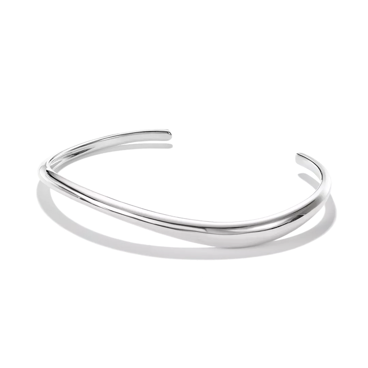 A polished silver open cuff bangle bracelet with a smooth, curved organic shape, displayed on a clean white background with a soft shadow.