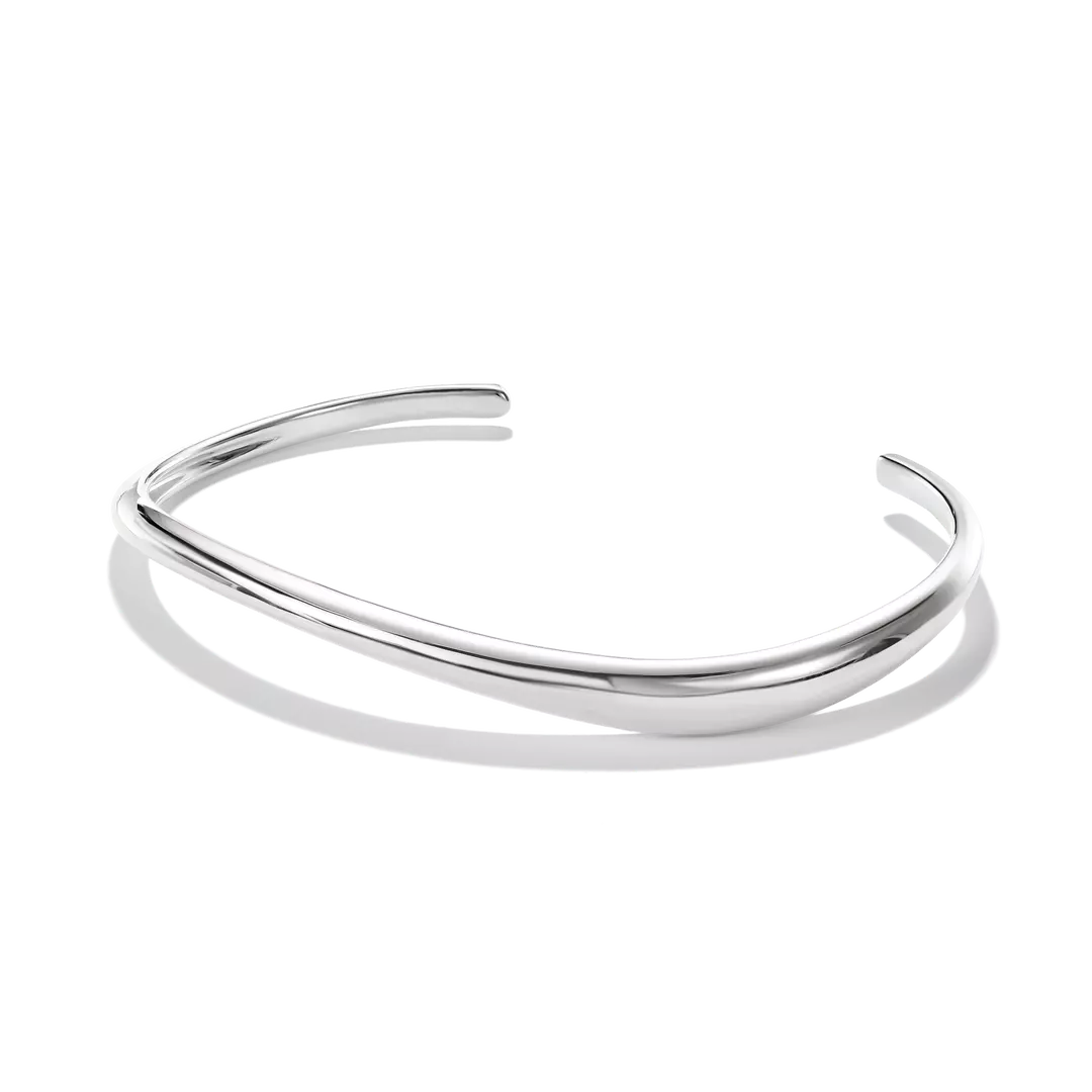 A polished silver open cuff bangle bracelet with a smooth, curved organic shape, displayed on a clean white background with a soft shadow.