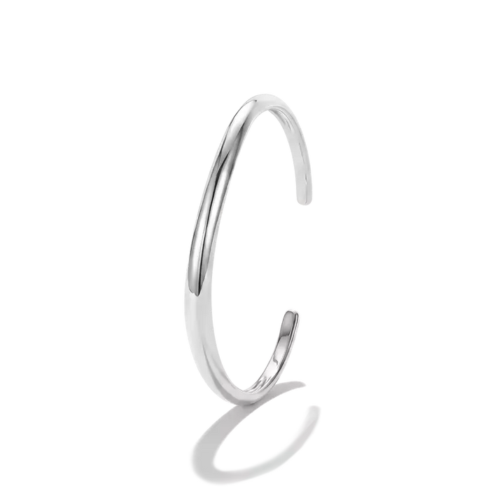 A polished silver-toned open cuff bangle with a smooth, tapered curve, shown on a clean white background with a soft shadow.