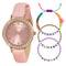 Pink watch with rose gold case and pink strap, accompanied by colorful friendship bracelets.