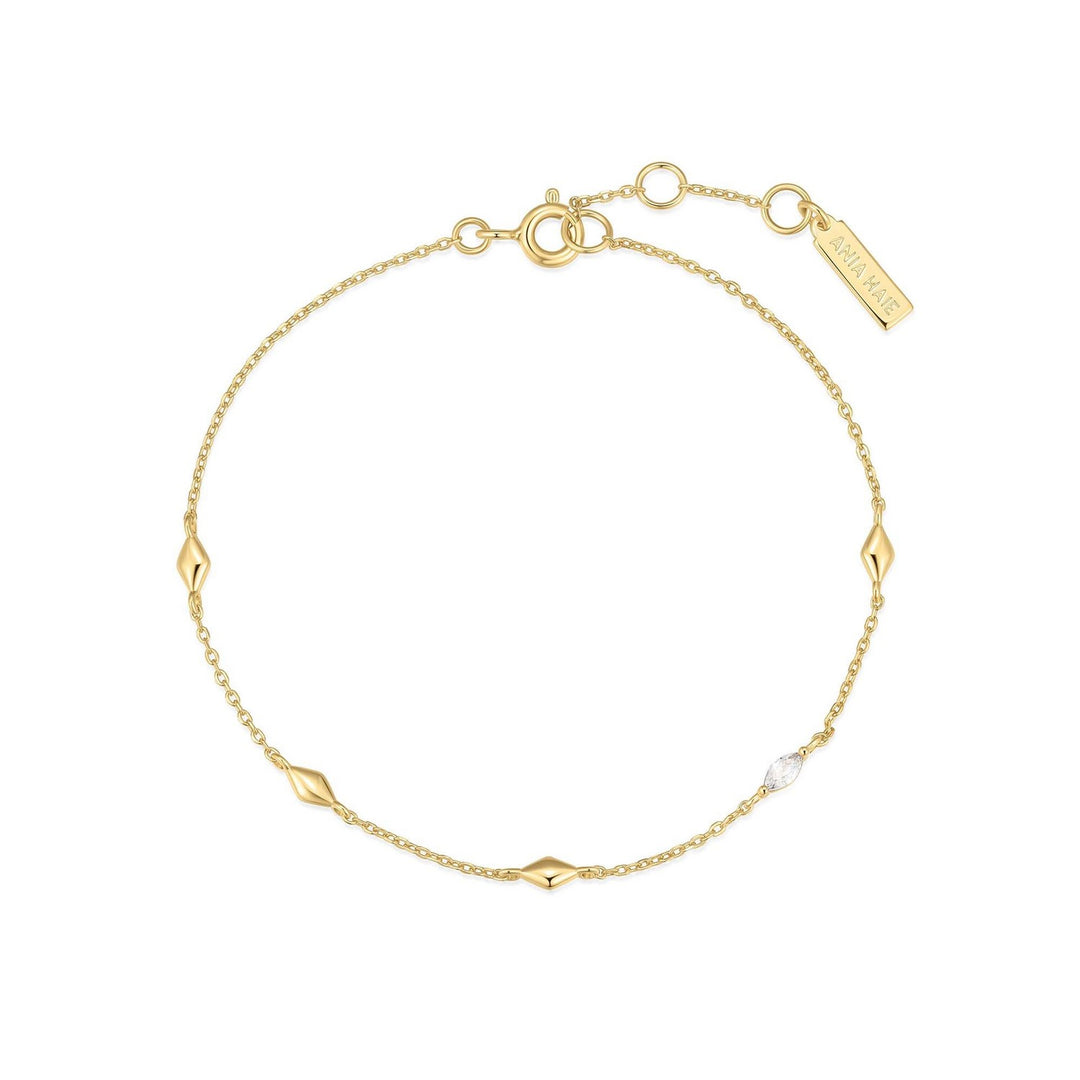 Gold bracelet with geometric links on a white background