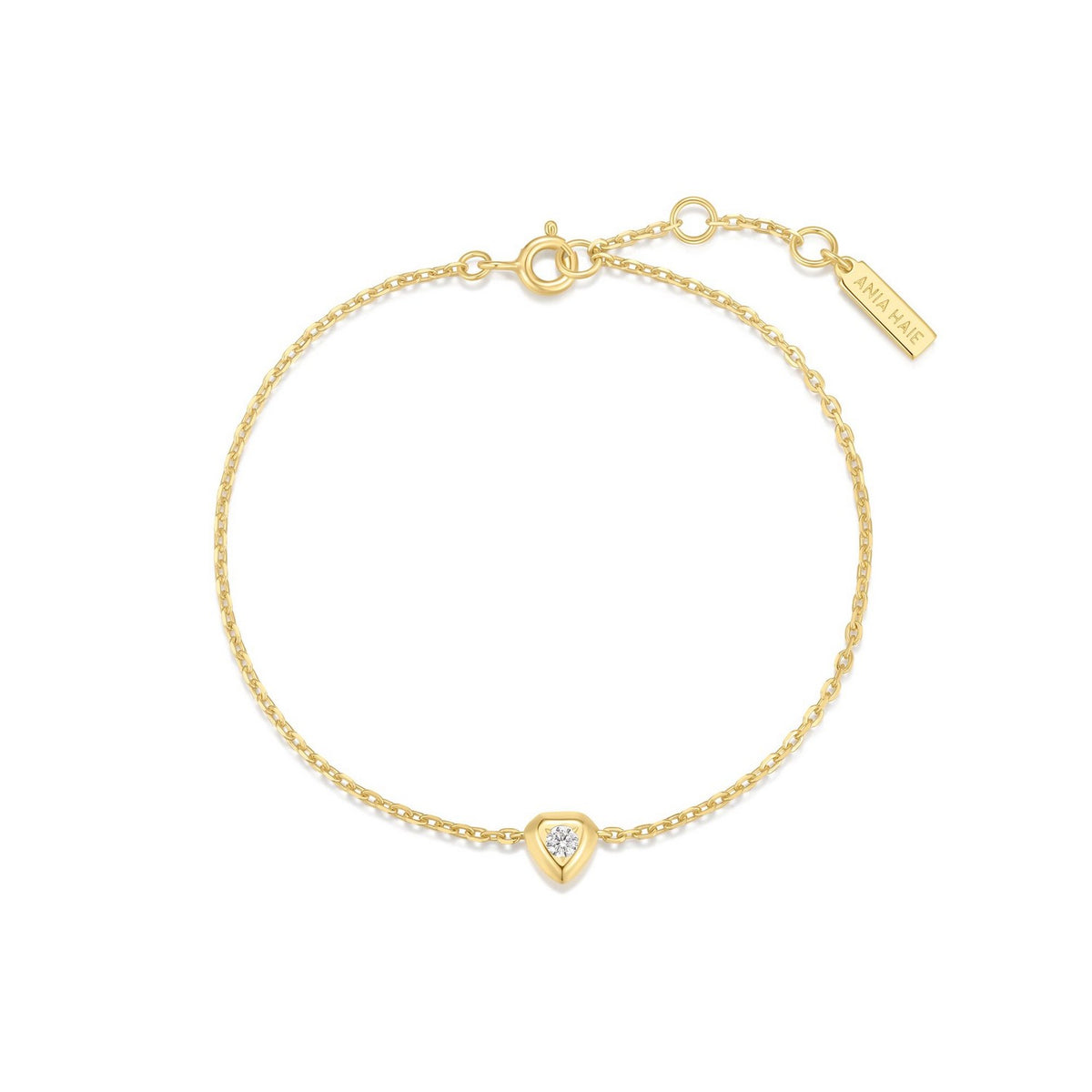 Gold bracelet with a heart-shaped diamond charm on a white background