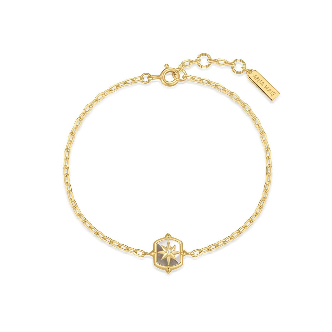 Gold bracelet with a star-shaped clasp on a white background