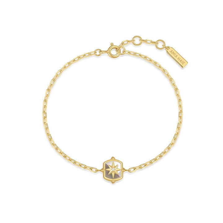Gold bracelet with a star-shaped clasp on a white background