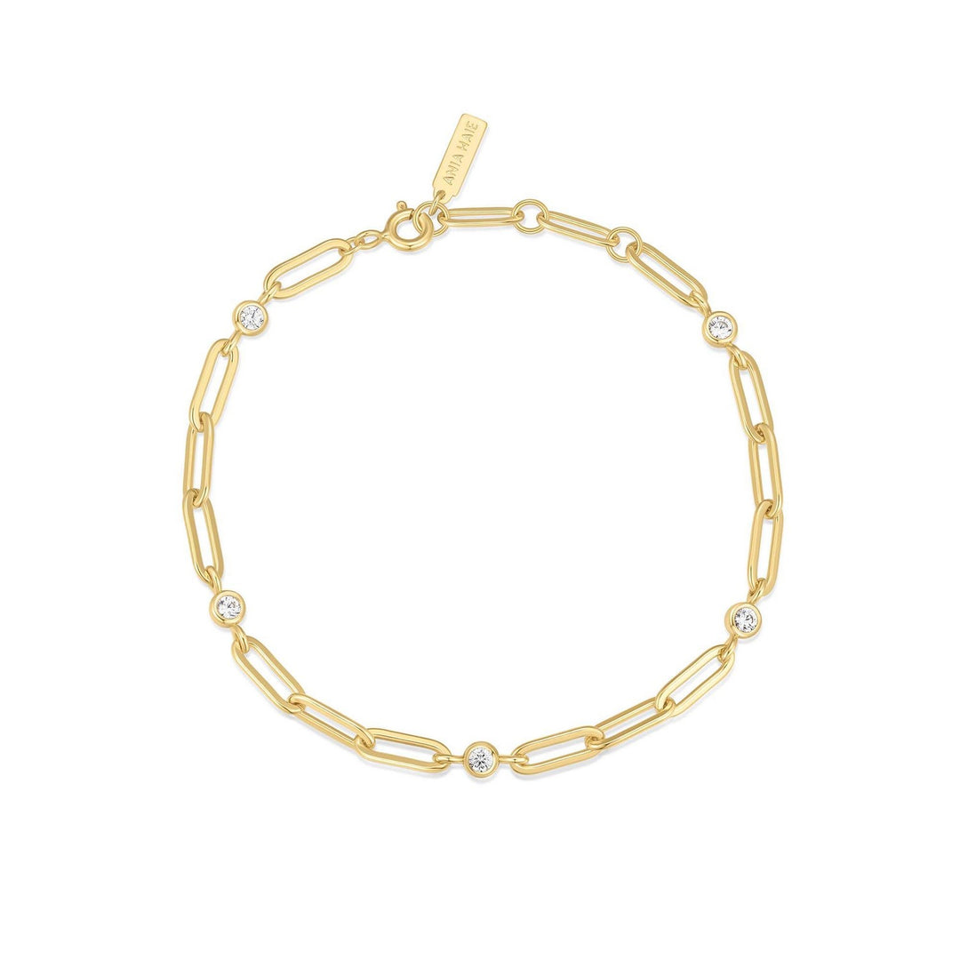 Gold chain bracelet with small crystals on a white background