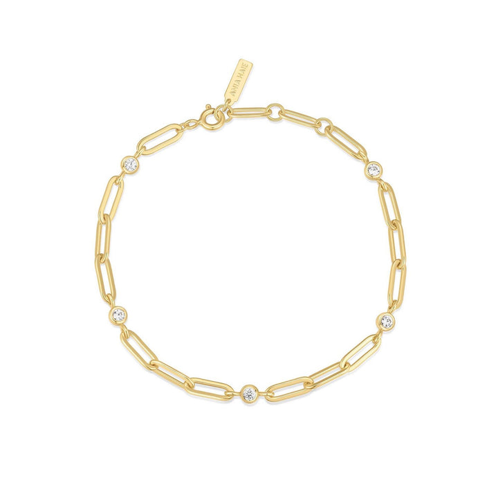 Gold chain bracelet with small crystals on a white background