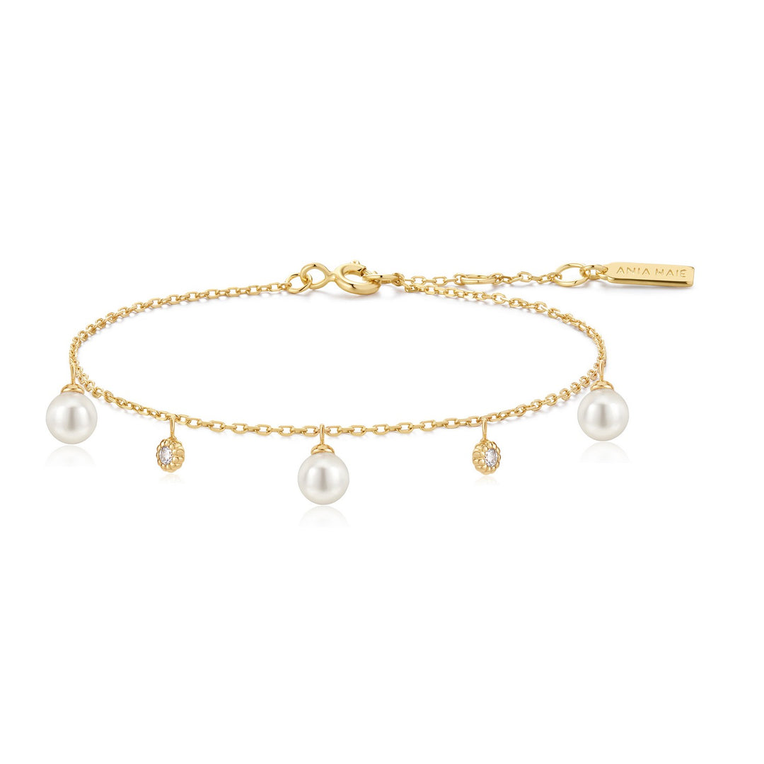 Gold bracelet with pearls and small diamonds on a white background