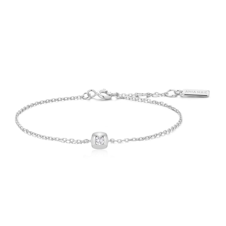 Silver bracelet with a small diamond charm on a white background