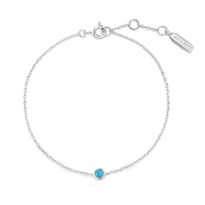 Silver bracelet with a blue gemstone on a white background