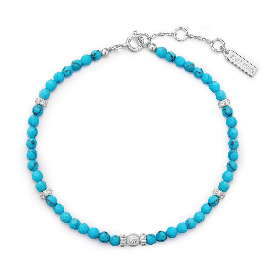 Turquoise beaded bracelet with silver clasp on a white background