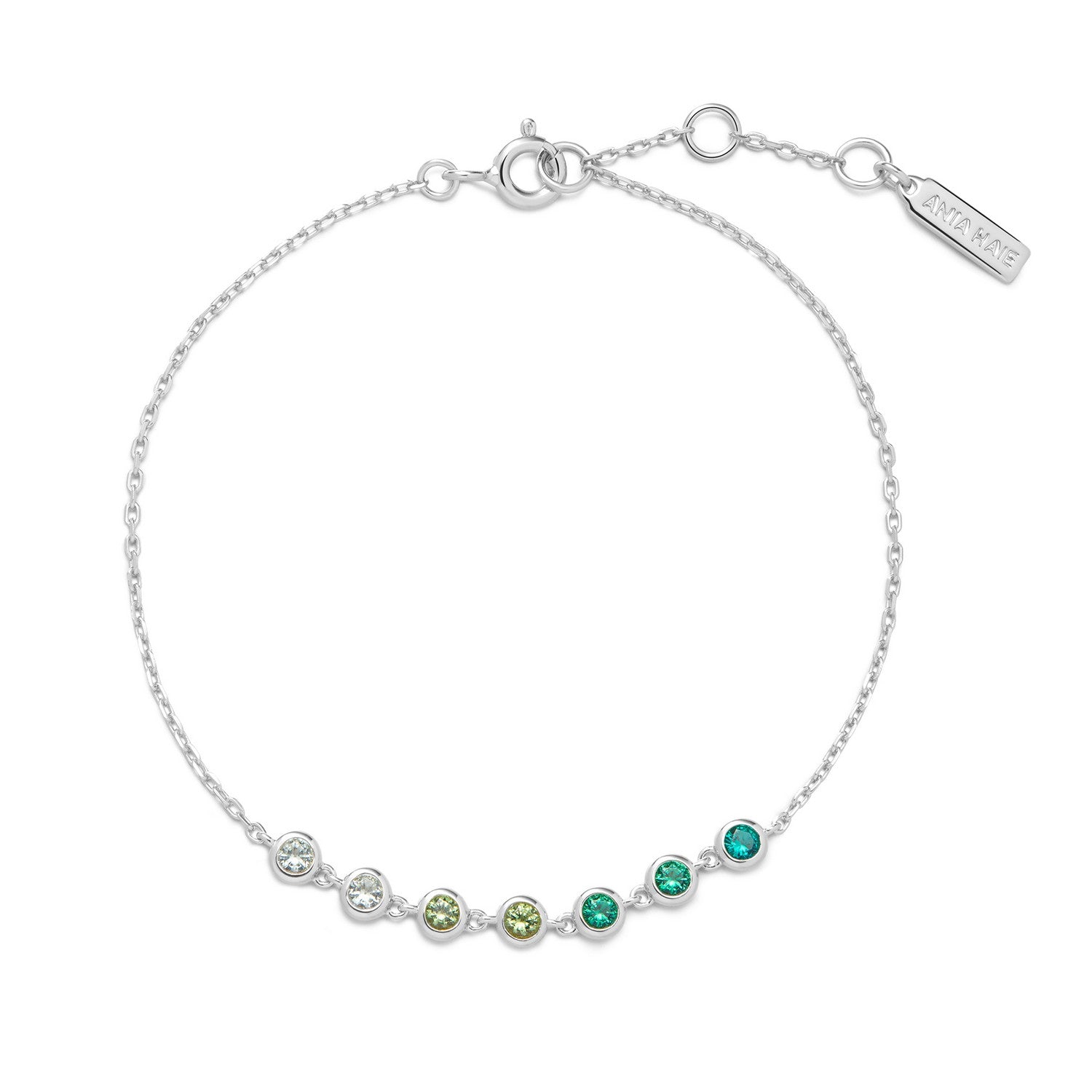 Silver bracelet with green gemstones on a white background