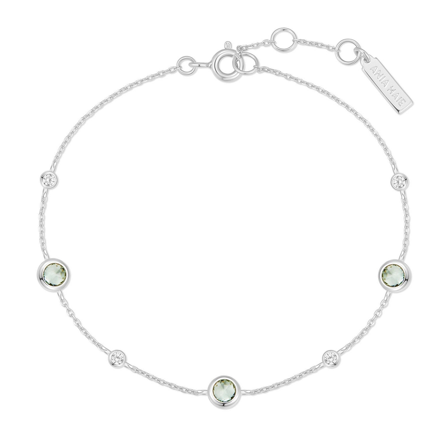 Silver bracelet with green gemstones on a white background