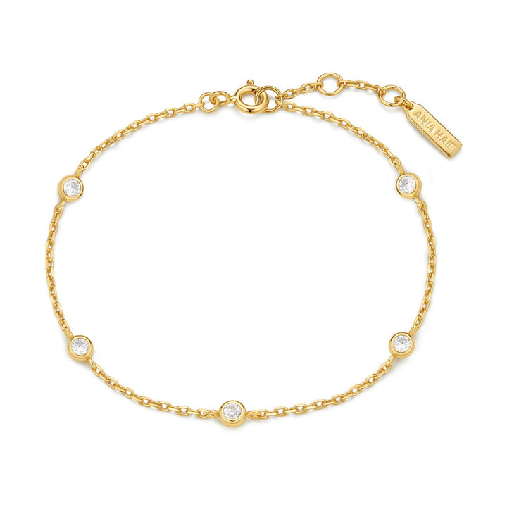 Gold bracelet with small diamonds on a white background
