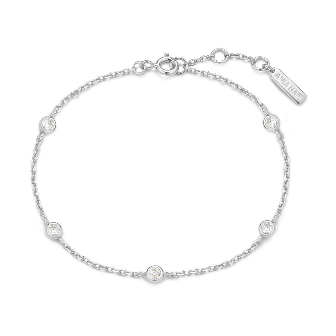 Silver bracelet with small round stones on a white background