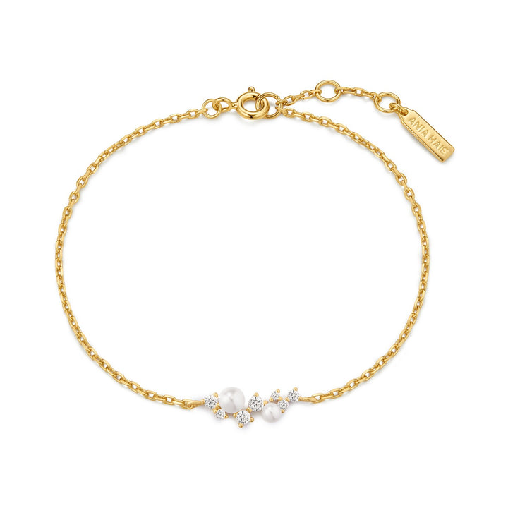 Gold bracelet with pearls and diamonds on a white background