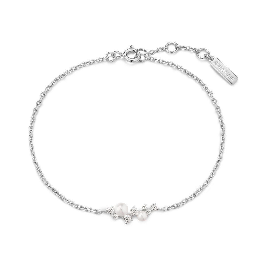 Silver bracelet with small pearls on a white background