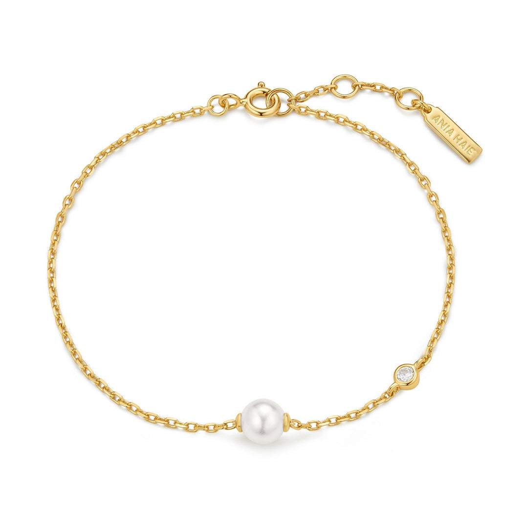 Gold bracelet with a pearl on a white background