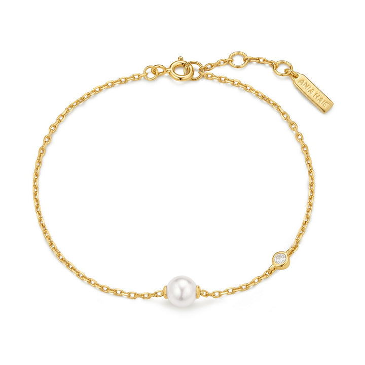Gold bracelet with a pearl on a white background